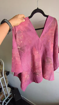 Close-up video of leaf prints on magenta mul cotton, Slowthreads ecoprint top